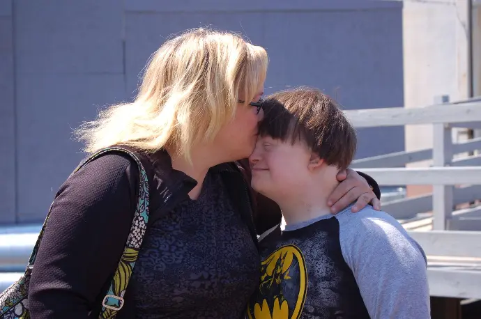 Image showing a mother kissing her son on the forehead having a happy moment
