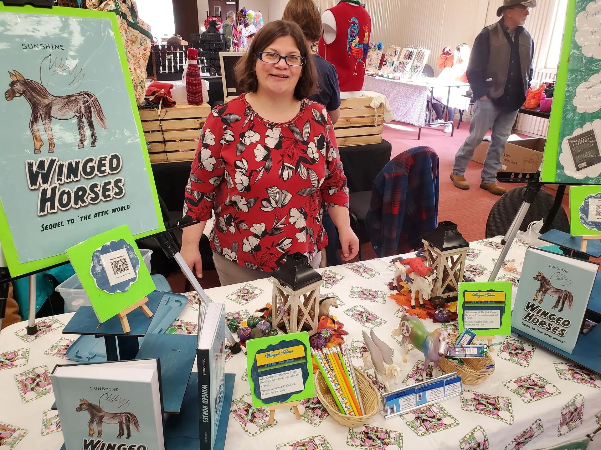 Image showing a participant promoting a book titled winged horses