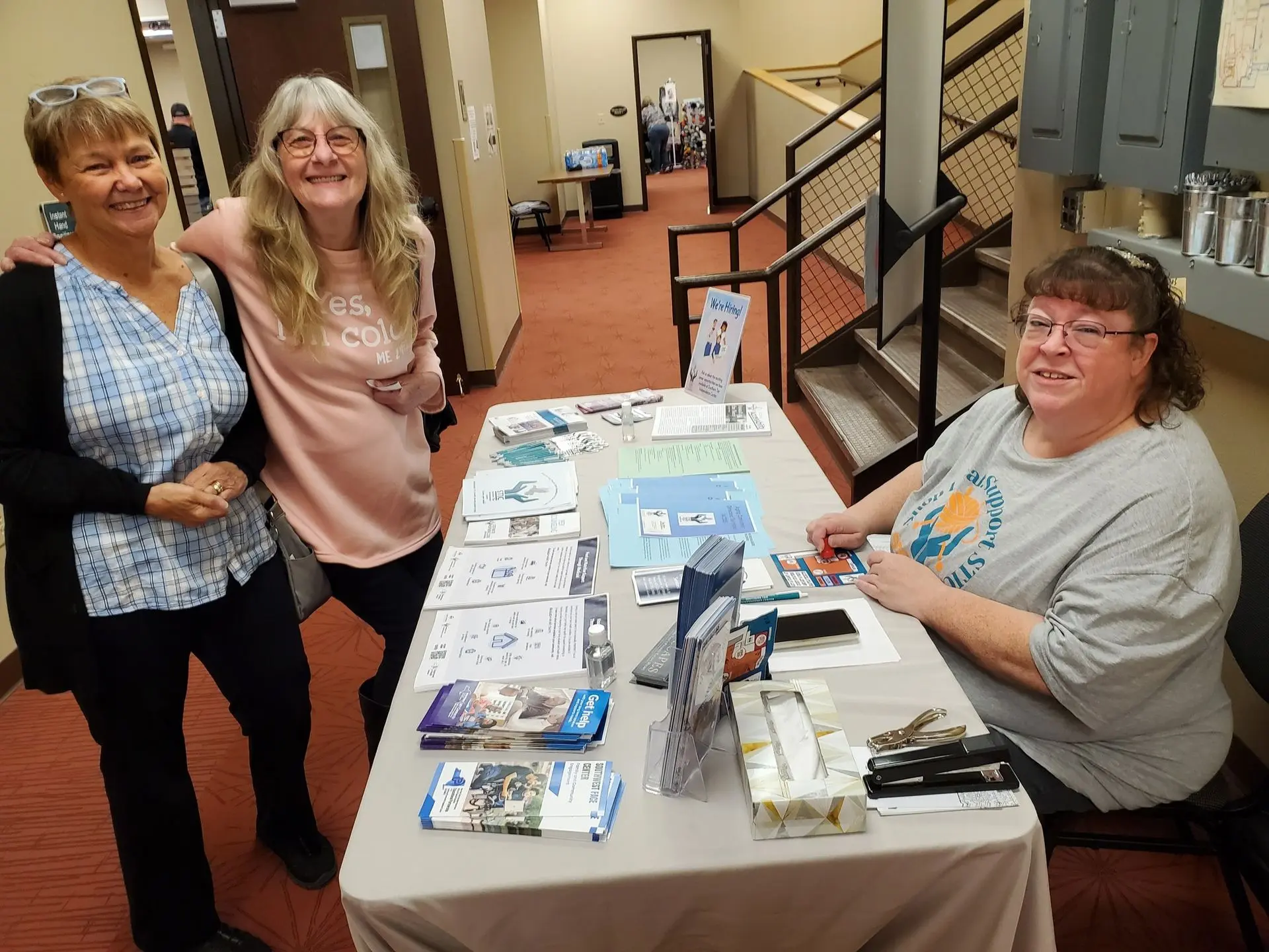 Image showing STIC staff and a visitor chatting at the information table